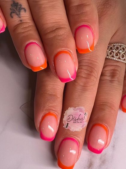 A fun and vibrant take on the French manicure. This set features alternating hot pink and bright orange tips for a playful, summery look.