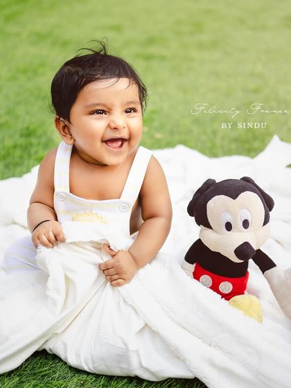 A big, joyful laugh from this little one during his outdoor session with his friend Mickey Mouse.