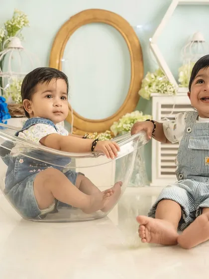The joy of brotherhood. This twin milestone session captures a beautiful, candid moment of laughter between two brothers.