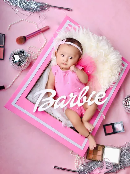 An overhead shot of the Barbie box setup, showing all the fun details like the disco ball, makeup brushes, and pearl necklaces that make this theme special.