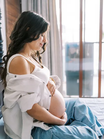 A quiet, contemplative portrait of a mother-to-be. I used the soft window light to create this serene atmosphere, focusing on her peaceful expression as she connects with her baby. This is a beautiful way to remember the feeling of pregnancy.