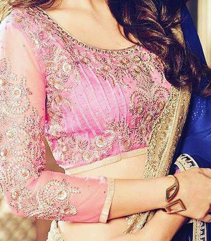 A pink blouse with full-length sheer sleeves and heavy embroidery. This classic design offers an elegant look while providing more coverage.