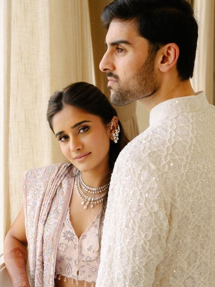 A romantic couple portrait from a Roka ceremony. The bride's soft makeup and wavy hair perfectly match her delicate pastel outfit.