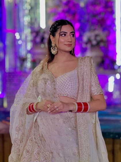 A closer look at my reception makeup. A braided hairstyle with soft, glowing makeup and my red 'chura' for a touch of tradition.