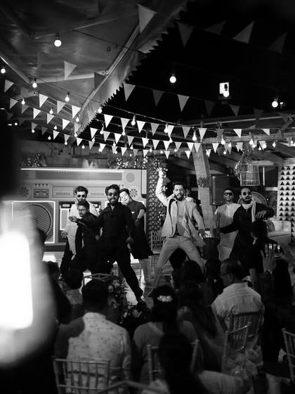 A creative black and white shot of the groom's dance performance, framed by a lightbulb for an artistic effect.