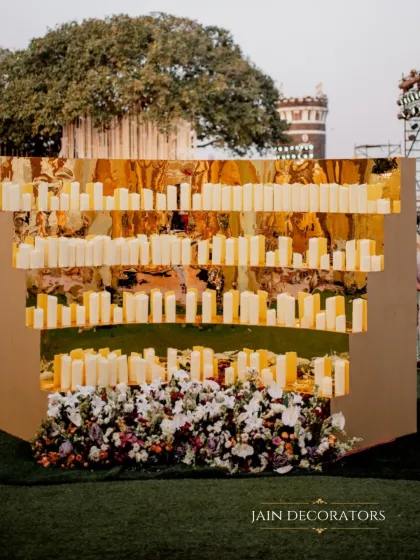 A modern and artistic candle wall. I designed this installation with layers of golden mirrors and rows of candles to create a warm, glowing, and incredibly chic backdrop.