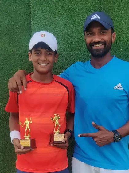 Rishikesh Mane with his coach and his two runner-up trophies from the U-12 singles and doubles events at the All India National Series in Jhajjar.