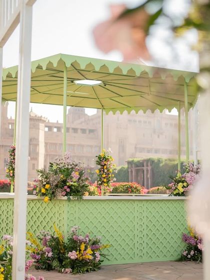 The light green bar area, with its trellis detailing and scalloped roof, perfectly complements the garden setting.
