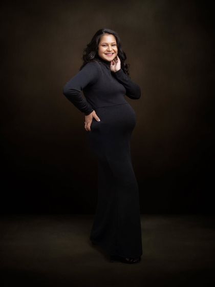 There's a quiet strength in simplicity. This portrait says it all, with no props or distractions, just confidence, elegance, and the joy of motherhood in a classic black dress.