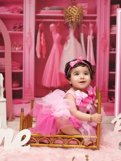 Another angle from our popular Barbie-themed first birthday session, showing the detailed closet backdrop and fun props that make the photos pop.