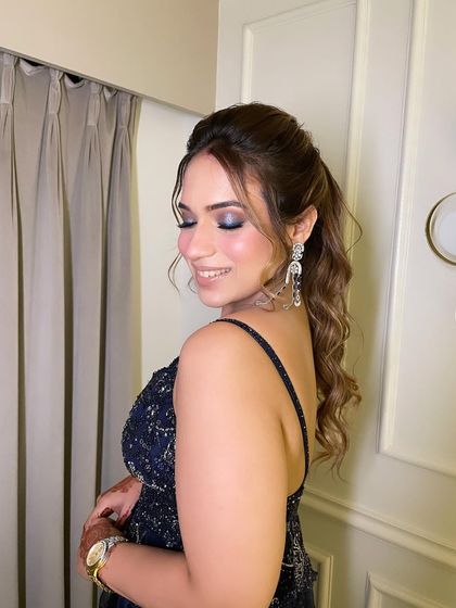 The complete look, with a chic wavy ponytail and statement earrings. This is how you create a cohesive and glamorous style for any party.