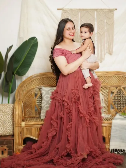 A full-length portrait of a mother and her child, showcasing the beautiful flow of our client-closet gown.