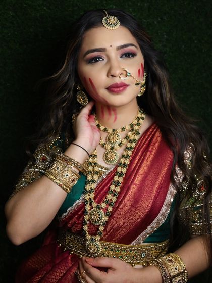 A festive Holi-themed shoot featuring the red and green half-saree. The outfit's rich colors are perfect for celebrations.