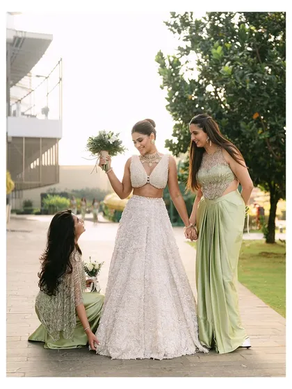 A sweet moment between the bride and her bridesmaids. Their loving interactions and shared joy highlight the importance of friendship on a wedding day.