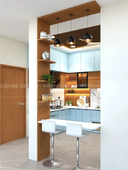 An open kitchen concept with a wooden partition that doubles as a breakfast bar. The dual-tone blue and wood cabinets create a fresh and modern look.