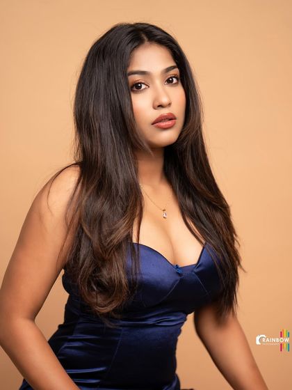 A duplicate of 14, this studio portrait of Pooja Ramesh in a striking blue satin dress makes the color and texture of the dress stand out.
