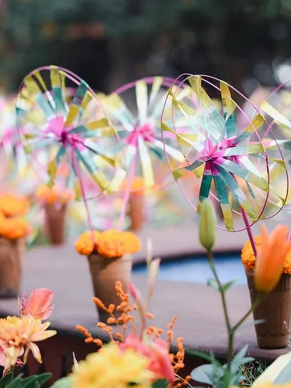 A detail from a garden Mehendi, where colorful pinwheels were placed in terracotta cones. This playful element added a touch of handmade charm and whimsy to the vibrant, sun-kissed setting.