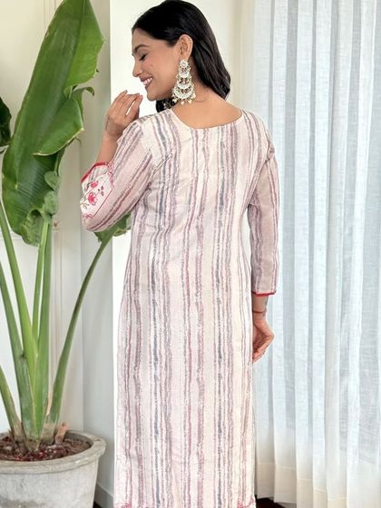 This off-white pure muslin kurta set is all about subtle stripes and floral details. It's a versatile piece that you can style for both casual and semi-formal occasions.