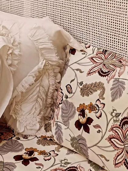 A close-up view of the natural cane headboard, showing the fine weaving. This detail adds a layer of texture and handcrafted quality to the bedroom furniture set.