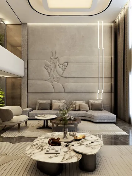 Simplicity and serenity in a space where minimalism breathes luxury. This double-height living room features a subdued color palette and clean lines, with a custom embossed wall detail and sculptural marble coffee tables creating a tranquil sanctuary.