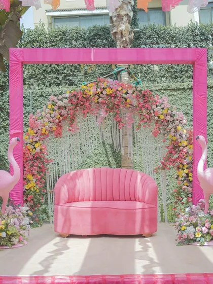 Who says a Haldi has to be all yellow? We designed this vibrant pastel Haldi ceremony with shades of pink, using reusable props like the flamingo figures and a plush velvet sofa to create a fun, modern, and picture perfect setting.