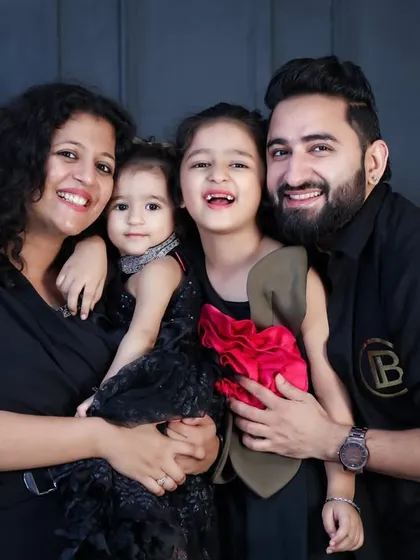 A classic family portrait that radiates happiness. In the studio, with a simple background, all the focus is on your family's smiles and connection. This beautiful family of four shows how timeless these photos can be.