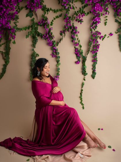 I love playing with color and florals. This mom-to-be looks radiant in a rich magenta gown, seated beneath a cascade of beautiful purple bougainvillea.