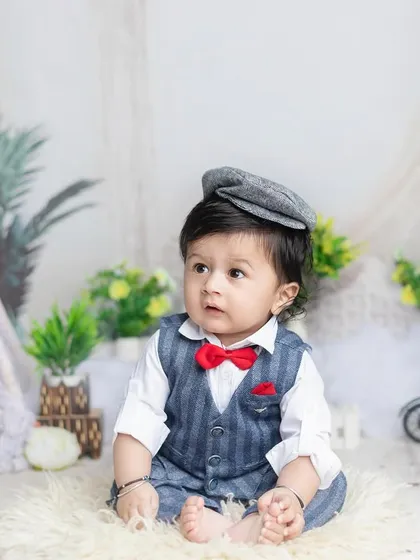 Adding a newsboy cap completes the handsome little gentleman look. Props can add so much character!