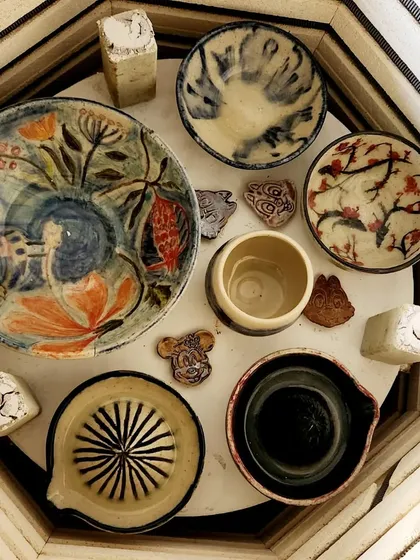 This is the most exciting moment: opening the kiln to see the final, transformed pieces. The heat works its magic, revealing the vibrant colors and glossy finish of everyone's hard work.