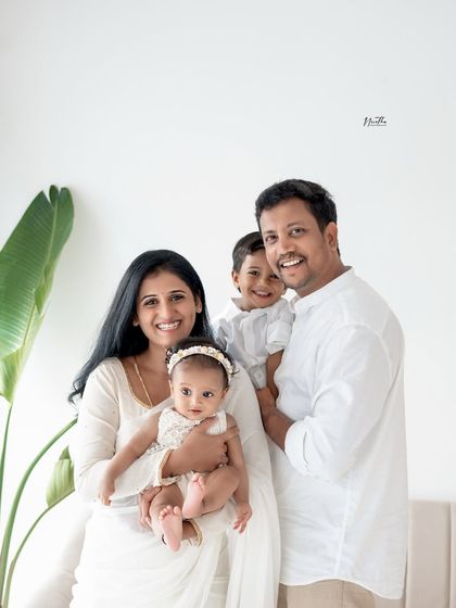 A beautiful family of four dressed in white, creating a classic and cohesive portrait.