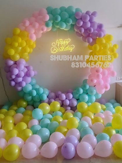 A cheerful and colorful pastel balloon ring that fills the room with joy, complete with a neon sign.