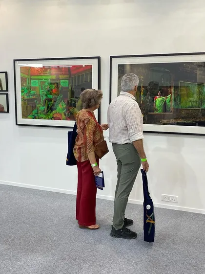 Visitors admiring the large photographs on display.