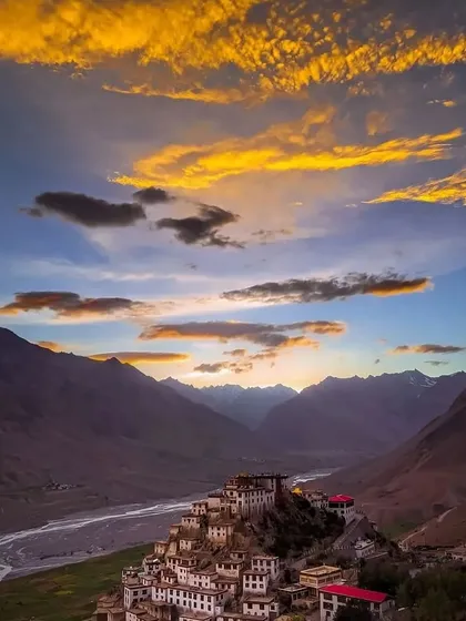 Another stunning view of the Key Monastery at dusk, with golden clouds painting the sky. The contrast between the warm sky and the cold mountains is what makes Spiti sunsets so epic.