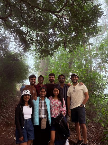 A group of friends in a misty forest trail in Kodaikanal.