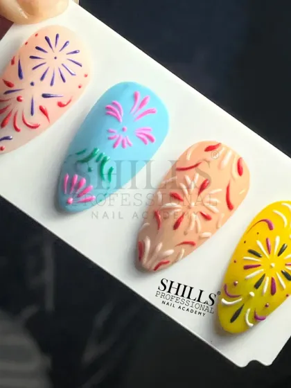 A set of four nails with colorful, hand-painted firework designs, perfect for celebrating Diwali or New Year's Eve.