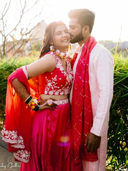 A playful kiss on the cheek captures a moment of pure happiness and affection. The golden hour light adds a warm glow to this beautiful pre-wedding portrait.