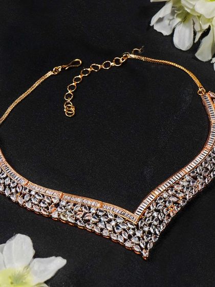 This shot of a rose gold necklace is styled with soft white flowers to create a romantic and elegant mood. It's perfect for wedding or occasion-wear collections.