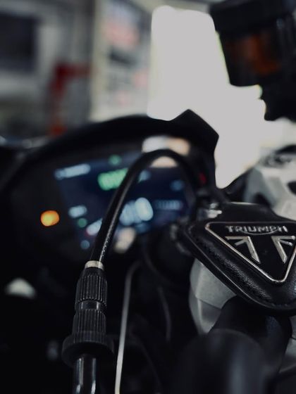 The front brake reservoir and controls on the Triumph.