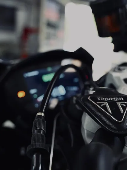 The front brake reservoir and controls on the Triumph.