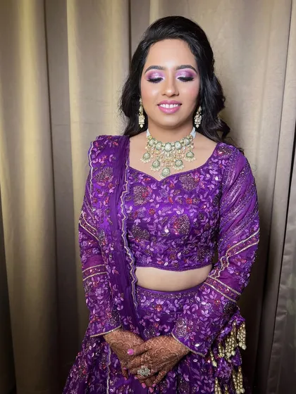 This client wanted a bold and glamorous look for her event. I created a dramatic purple smokey eye to match her embroidered lehenga, keeping the rest of the makeup balanced and radiant.