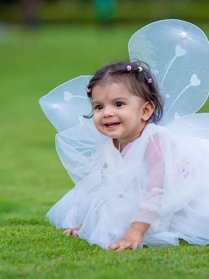 Cute as a button. This little fairy is spreading magic in the garden.