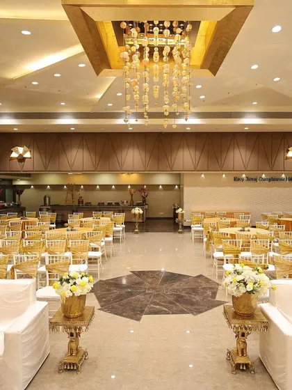 Another view of the spacious banquet hall, highlighting the modern chandeliers and clean, elegant setup before the Mehendi event begins.