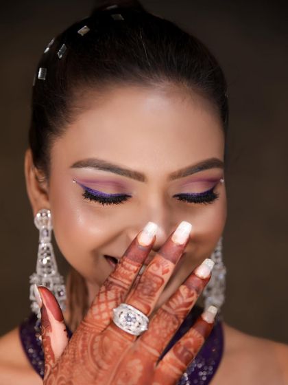 A playful shot showing off the beautiful purple eye makeup. We love it when our clients have fun and feel confident in their looks.