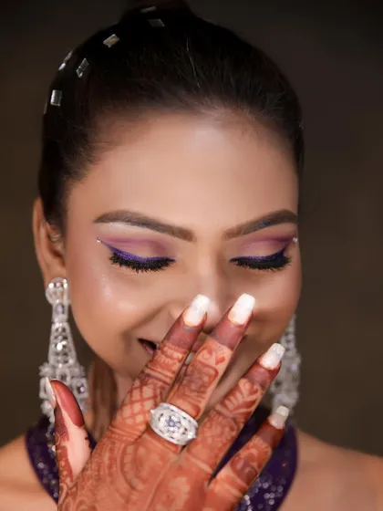 A playful shot showing off the beautiful purple eye makeup. We love it when our clients have fun and feel confident in their looks.