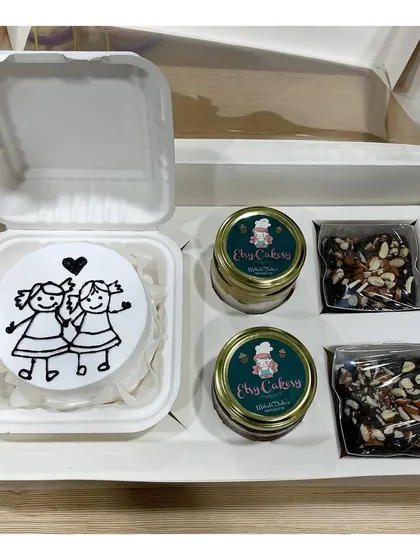 A custom hamper box featuring a bento cake, two cake jars, and two brownies. I can create these gift boxes for any occasion.