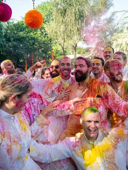 The vibrant chaos of a Holi celebration. This group shot captures the joy and energy of friends covered in colors.
