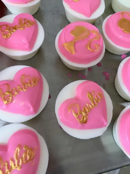 Barbie-themed soaps with the iconic logo in pink and gold, perfect for a trendy and fun party favor.