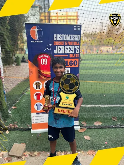 Anirut Varanje, named Best Player for the U13 category, holding his individual award and the team's championship trophy.