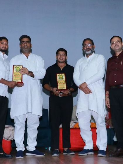 On stage receiving an award for our contribution to sports. Recognition like this fuels our drive to work even harder.