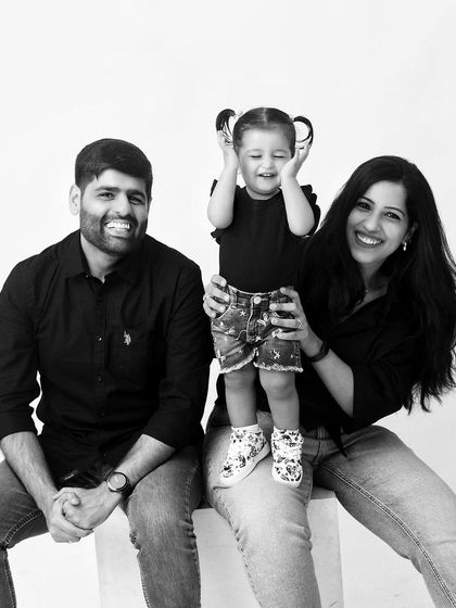 A beautiful black and white photo capturing a moment of pure joy. The daughter's happy, candid expression makes this family portrait extra special.